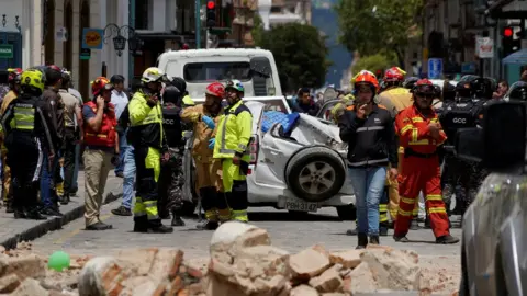 Reuters Emergency services survey the damage in Cuenca