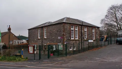 Richard Dorrell An old stone school building in Dumfries and Galloway on a grey day