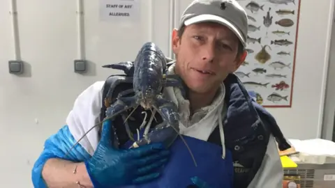 Tony McLean with the blue lobster on his shoulder