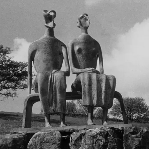 CHRISTIE'S IMAGES LTD. 2026 A photograph of the bronze sculpture of a man and woman sitting on a bench in a park