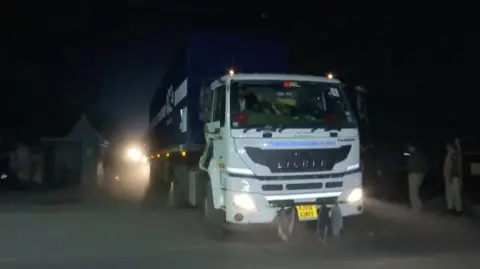 ANI A container truck carrying toxic waste from Bhopal city with police men present 