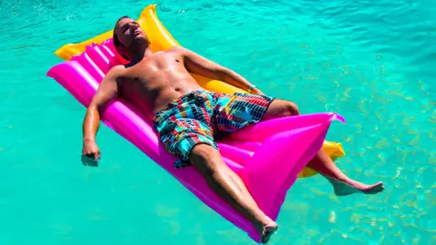 Getty Images Man on lilo