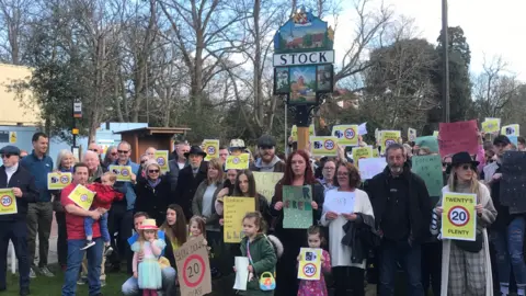 Matt Knight/BBC People taking part in a protest to lower road speed limit to 20mph