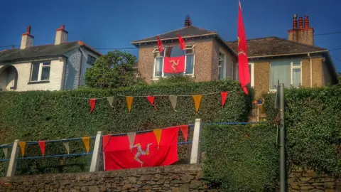 Alan Kneen Manx Flags outside houses on Tynwald Day 2018