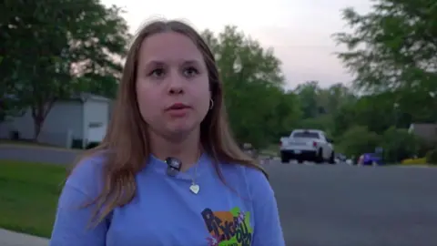 A young woman in a blue t-shirt 