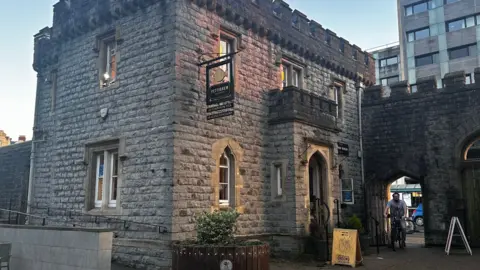 A stone building, which is now open as a tea room at the entrance to Bute Park, Cardiff