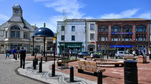 Cumberland Council A general view of Green Market with new wooden seating, information boards and the memorial flagstones.