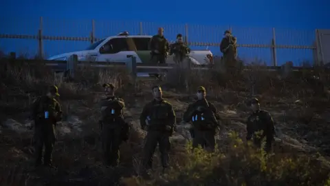 Getty Images US Border Patrol agents stand guard as they look for illegal immigrants