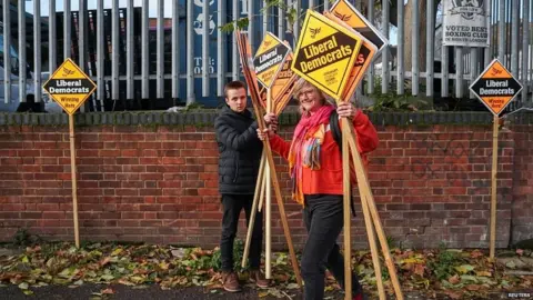 Reuters Lib Dem activists putting up placards outside the Total Boxer gym