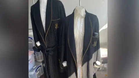 Anna Tennant Images that Anna Tennant took of the Harry Potter school costumes, complete with black blazers with gold patterns on them