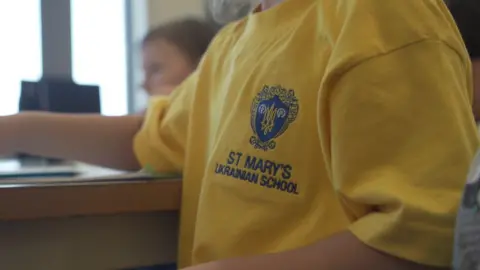 A close up of the St Mary's Ukrianian school badge