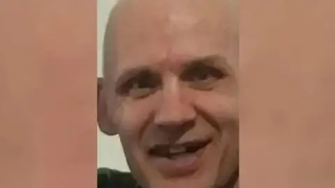 Kevin Ryan, a bald middle-aged man smiling at the camera.