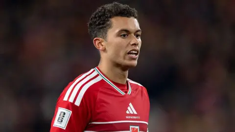 Forward Brennan Johnson in a Wales shirt 