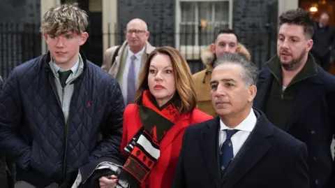 PA Media The gathered families in Downing Street speaking to the media