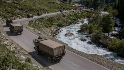 Getty Images GAGANGIR, KASHMIR, INDIA - SEPTEMBER 2: Indian army convoy carrying reinforcement and supplies, drive towards Leh, on a highway bordering China, on September 2, 2020 in Gagangir, India.
