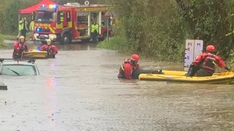 HIWFRS Firefighters rescuing car submerged in water