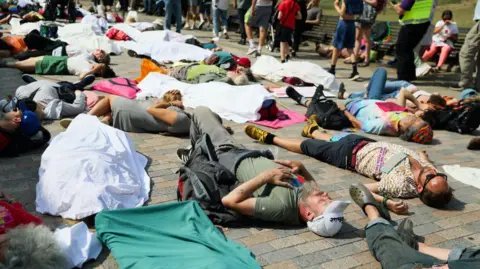 Getty Images Members of Extinction Rebellion lay on the streets outside of Windsor Castle on September 1, 2024 in Windsor.