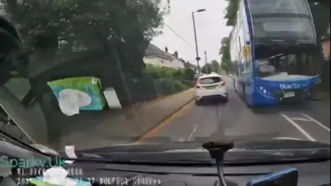 Bus appears coming towards middle of the road towards oncoming traffic