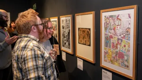 North Yorkshire Council People looking at artwork inspired by the hotel toilets