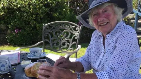 Beryl, an elderly lady, sitting in the garden.