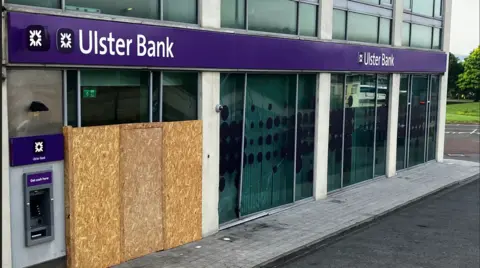 Boarded up windows in an Ulster Bank building