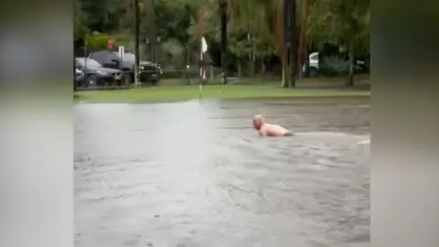 Man swims in puddle on Sydney golf course