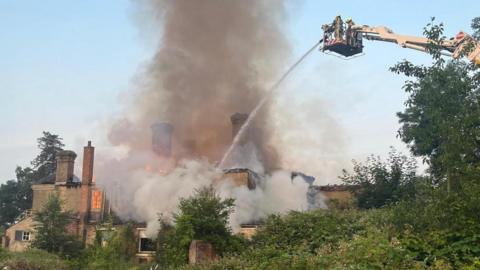 A derelict building on fire in Parsons Hill, Great Bromley