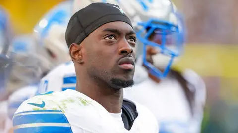 Terrion Arnold of the Detroit Lions looks on from the sideline during an NFL game against the Green Bay Packers in September 2025