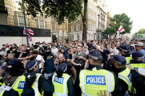 PA Police officers clash with protesters during the 'Enough is Enough' protest in Whitehall, London