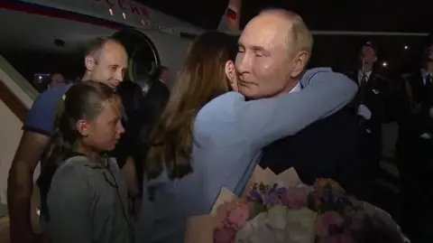 Former captive  hugging President Putin