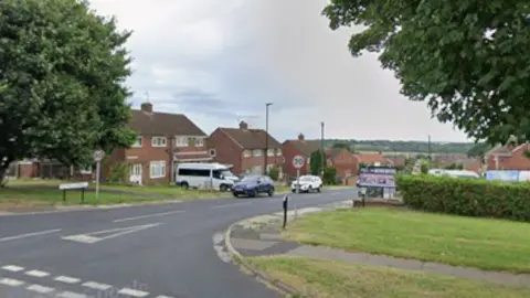 A junction leading into a residential road with 30mph signs at the entrance