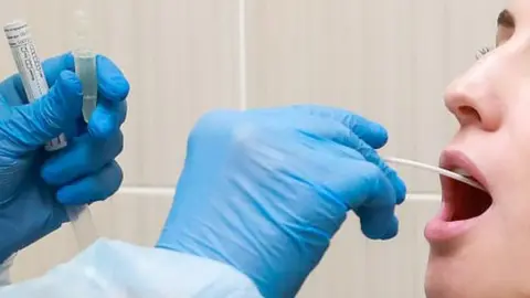 Getty Images woman having throat swab taken