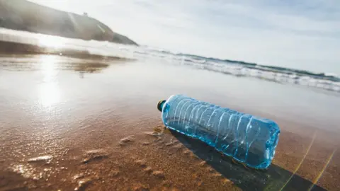 Getty Images An empty bottle on a beach