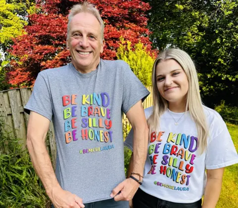 Family handout Gracie and her father wearing the T-shirts she designed