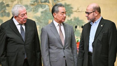 Fatah representative Mahmoud al-Aloul, China's Foreign Minister Wang Yi, and Hamas representative Mussa Abu Marzuk 