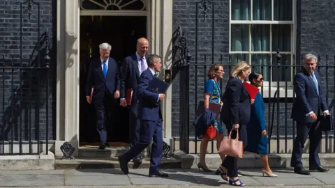 Getty Images Cabinet ministers leave 10 Downing Street at the end of the weekly cabinet meeting, July 2017