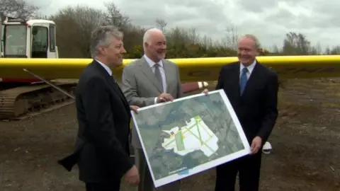 Former first and deputy first ministers Peter Robinson and Martin McGuinness at the site in 2013 with Terence Brannigan, former chair of the Maze Long Kesh Development Corporation