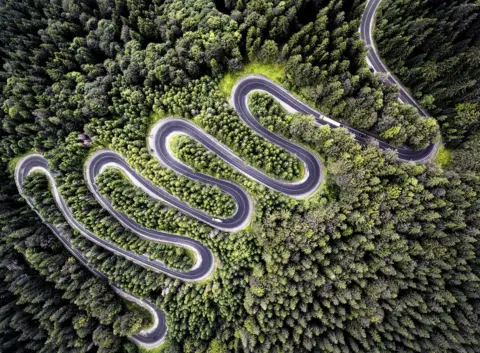 Calin Stan An aerial view of a winding road.