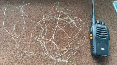 St Mary's Island Wildlife Conservation Society The white plastic netting which was removed from the seal. It is next to a walkie-talkie for scale.