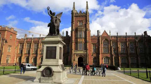 The QUB building with a blue sky and clouds