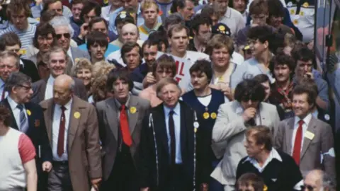 Getty Images Dennis Skinner and British trade unionist Arthur Scargill, are shown among people attending a rally in London in support of the striking miners in 1984