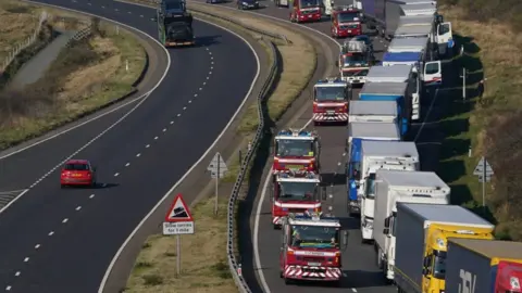 PA Media The convoy heading to Dover