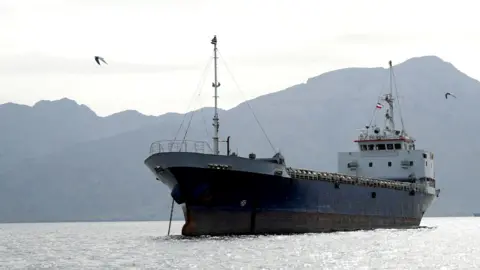  A vessel in the Strait of Hormuz, off the coast of Oman’s Musandam province, April 12, 2026