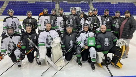BBC Sheffield Mavericks squad on the ice with the first aid kit