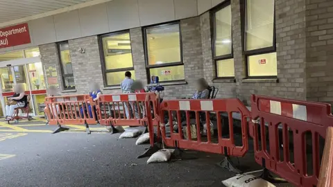 Submitted Patients sitting under blankets and a nurse outside accident and emergency at Addenbrooke's Hospital in Cambridge