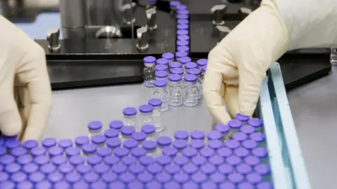 Reuters Vials of coronavirus disease (COVID-19) vaccine candidate BNT162b2 are sorted at a Pfizer facility in Puurs, Belgium in an undated still image from video.