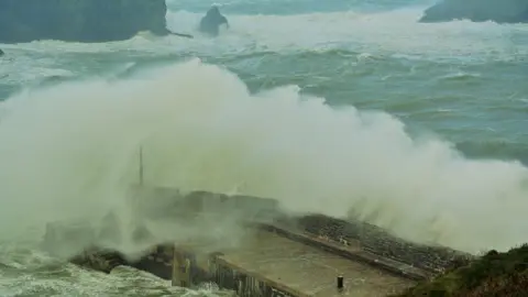 Bob Felche  Waves crashing over Mullion harbour in Cornwall