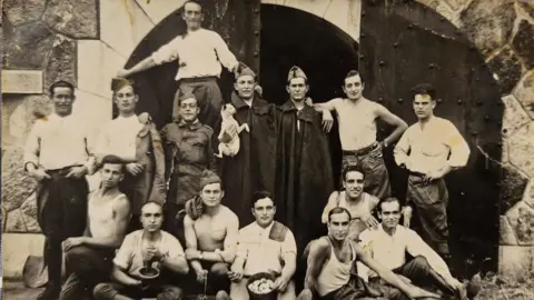 Old photo of Ramon Lluch-Planes with other men. 
