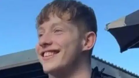 Police Scotland A young man, Dylan Geddes, smiling and looking away from the camera.