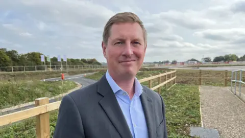 Shaun Whitmore/BBC Matt Stafford stood by a road